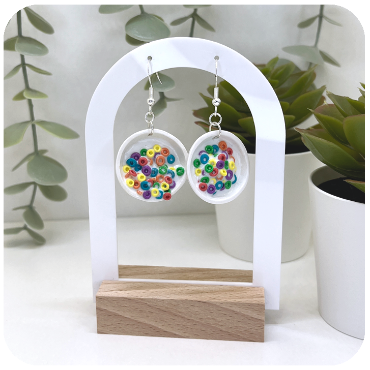Handmade polymer clay cereal bowl earrings with colourful miniature cereal pieces in tiny bowls.